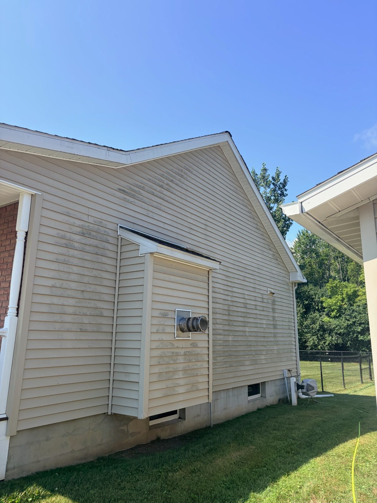Before: Two-story siding soft wash